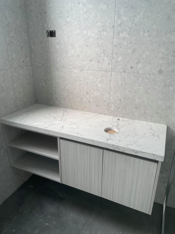 Floating bathroom vanity with a white marble-look stone top