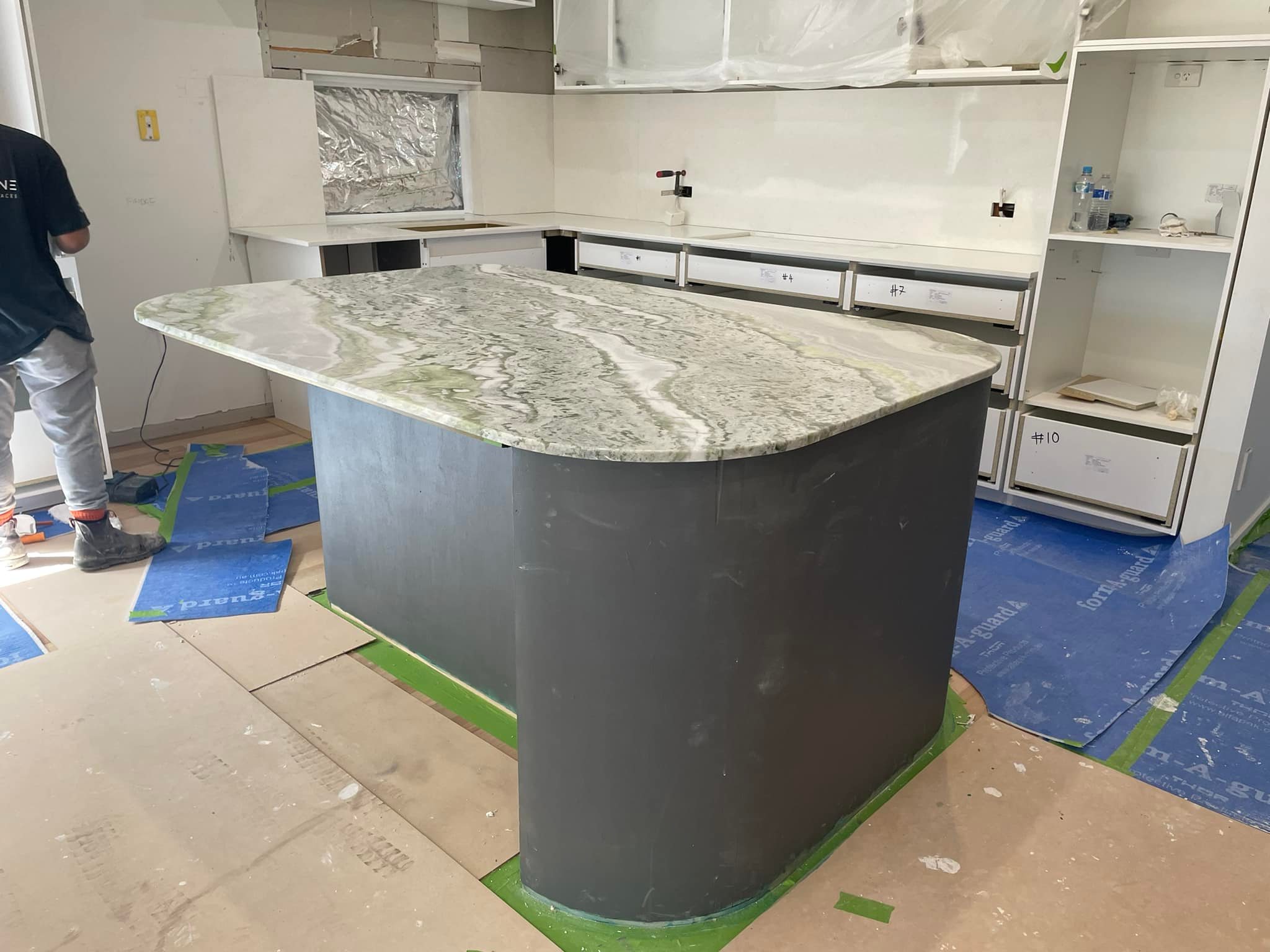 Rounded green-veined stone island top on a curved dark base