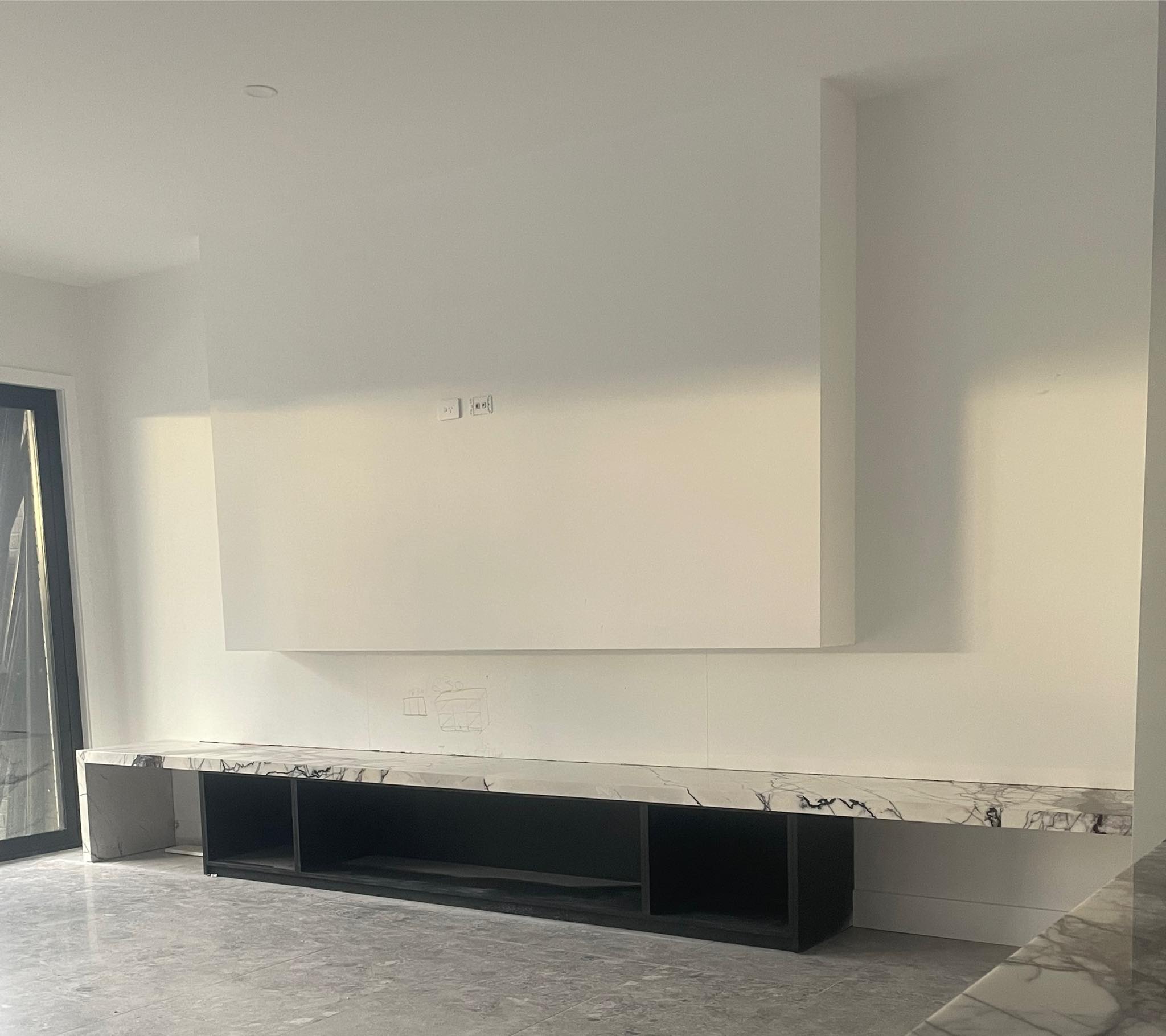Low floating marble-look bench with black open shelving below