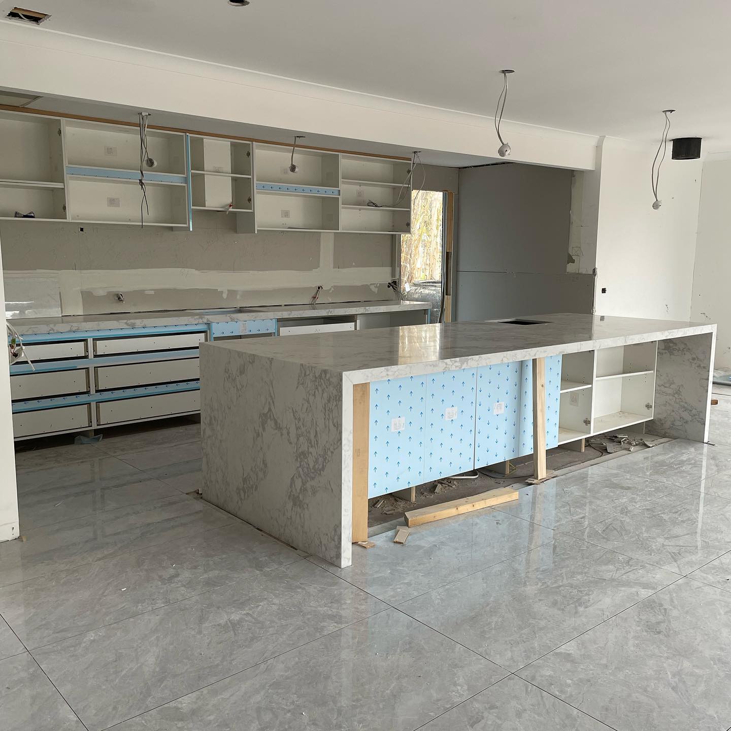 Large island with a white and grey veined waterfall stone top