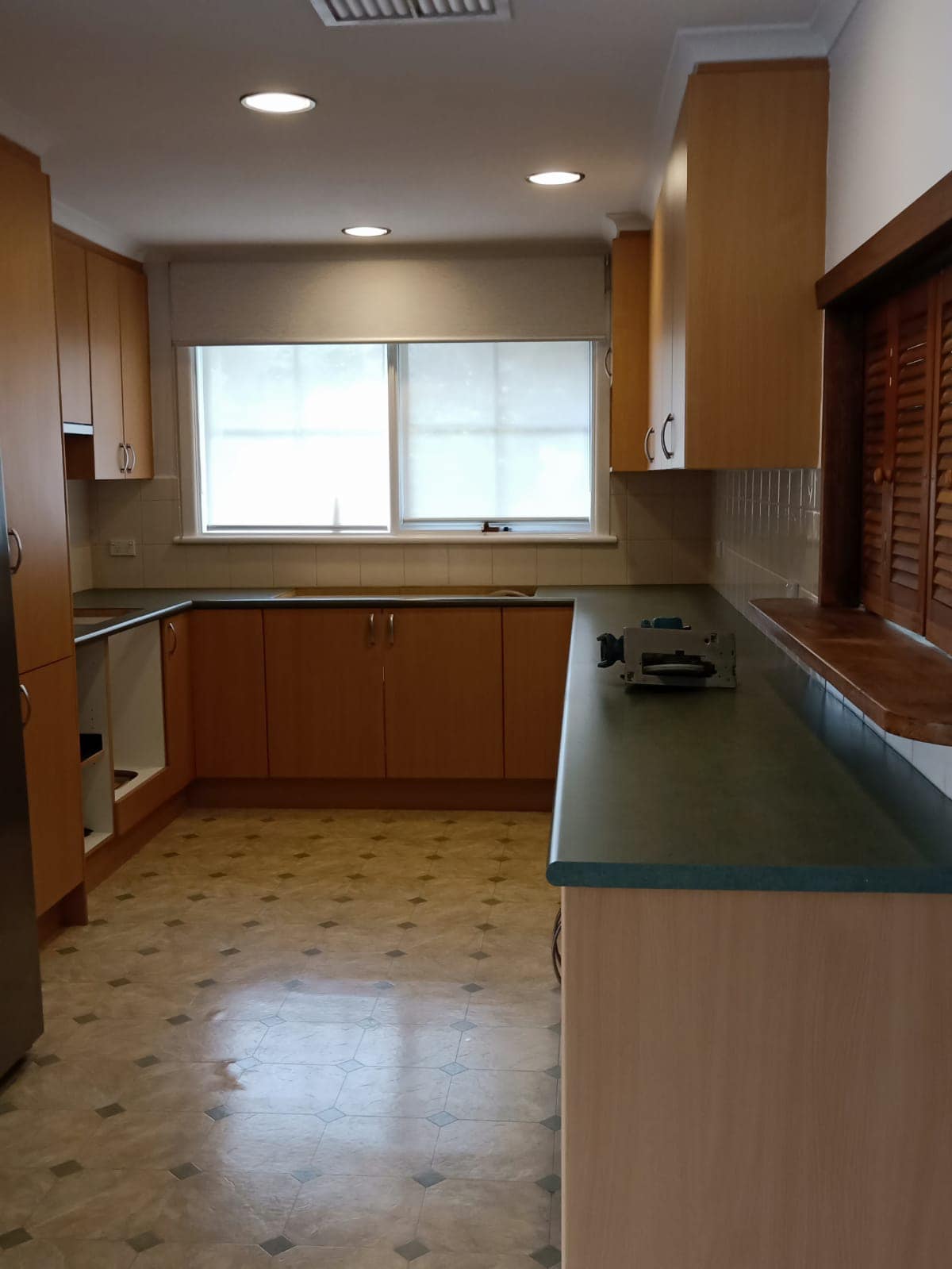 Timber kitchen with a dark green benchtop