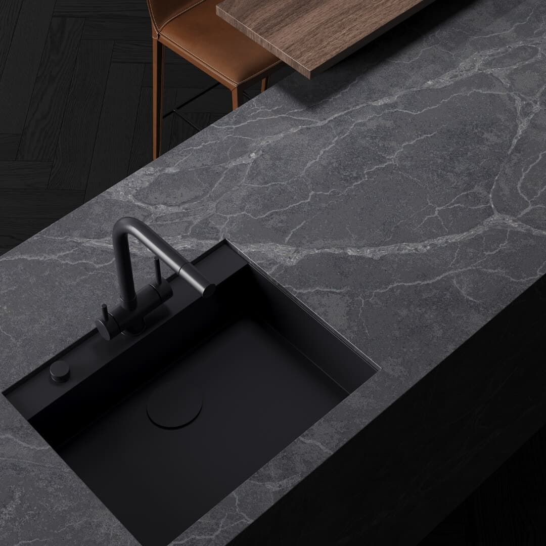 Dark grey veined stone benchtop with a black sink and tap