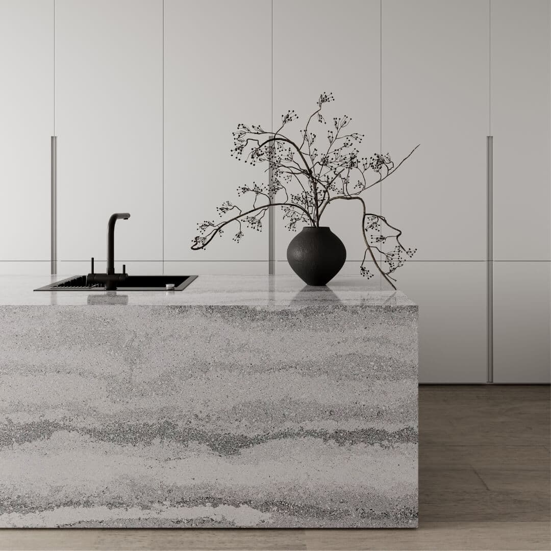 Grey Travertine stone on a kitchen island with a black sink